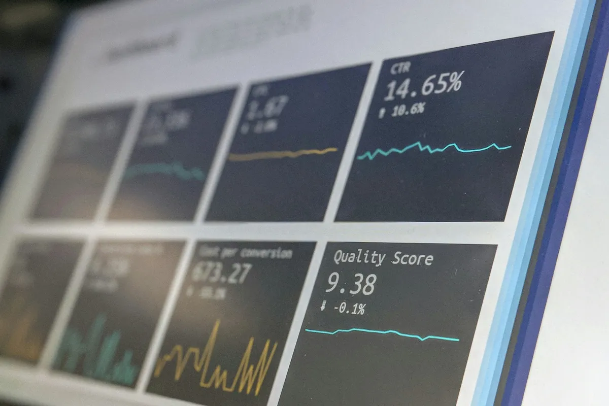 Angled close-up of a dashboard screen with metric tiles and line charts